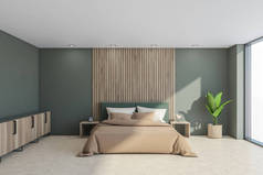 室内有床、餐具柜、浅绿色的墙壁和带有米黄色床单的床头板、木制细节、侧桌、植物、轻型混凝土地板和全景景观。3d渲染
