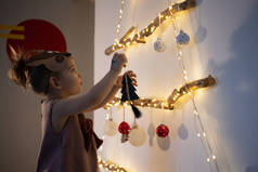 孩子们，家里装饰圣诞树的小女孩。生态友好型替代圣诞树