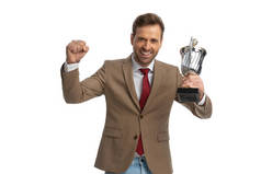 excited businessman celebrating success with his cup in the air and a smile on his face