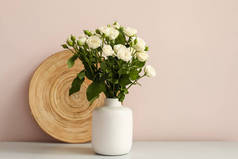 将一束美丽的玫瑰放在靠近轻墙的桌子上