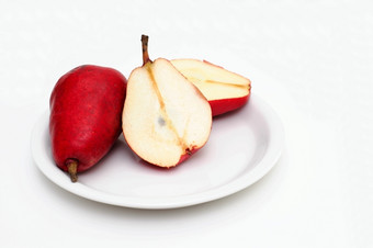 切片红色的梨红色的梨白色飞碟梨切片一半显示的核心而且种子