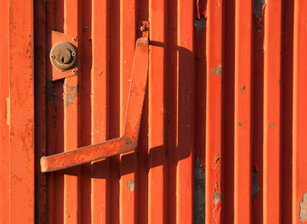 充满活力的橙色生锈的铁门背景纹理