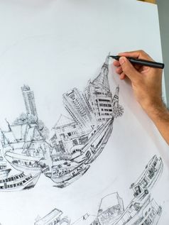 特写镜头艺术家手画黑色的墨水笔白色帆布的地方画架凹陷艺术关于运输和城市