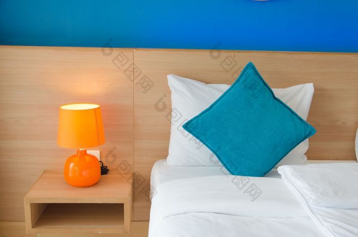蓝色的垫子和橙色灯的床上