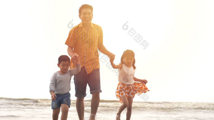 幸福父亲和儿子和女儿玩的海滩