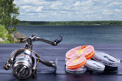 钓鱼卷五彩缤纷的e-boxes的董事会湖的背景钓鱼设备木背景
