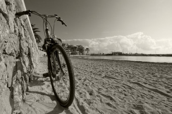 <strong>自行车</strong>倾斜对石头墙桑迪海滩阳光明媚的一天马略卡岛巴利阿里<strong>群</strong>岛岛屿西班牙
