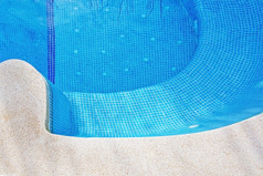 游泳池背景与混凝土石头和蓝色的瓷砖曲线