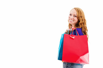 快乐年轻的红色头发的人女人与购物袋快乐笑年轻的红色头发的人女人与购物袋白色背景