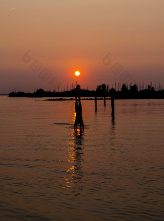 女孩做倒立的水在日落与的港海勒富特蚜虫和的船背景