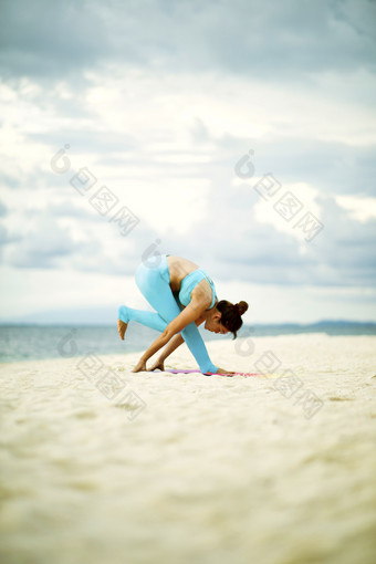女人玩瑜伽构成沙子海滩