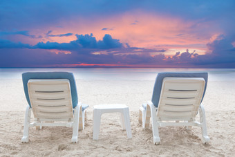 夫妻椅子海滩白色沙子与微暗的天空背景假期和放松场景夫妻椅子海滩白色沙子与微暗的天空背景
