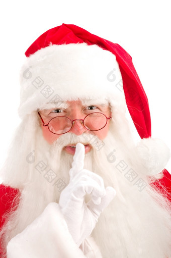圣诞老人老人看起来专心地通过他的眼镜直接的相机而且所有为沉默与他的手指他的嘴唇白色背景