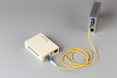 两个媒体转换器连接纤维电缆两个媒体转换器连接纤维电缆灰色背景