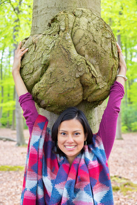 年轻的哥伦比亚女人拥抱树癌症山毛榉树