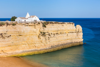 白色教堂陡峭的岩石蓝色的海小白色葡萄牙语教堂陡峭的岩石蓝色的海