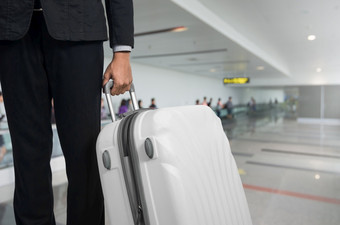 商人和手提箱的机场离开休息室飞机的模糊背景夏天假期概念旅行者手提箱机场终端等待区域商人和手提箱