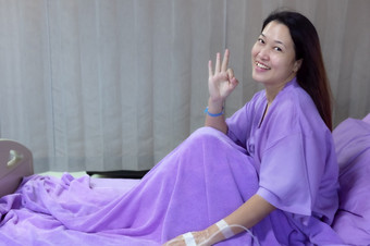年轻的亚洲女病人微笑和显示手势病人感觉快乐和舒适的与治疗和治疗<strong>医院</strong>床上<strong>医院</strong>房间医疗医疗保健概念医疗医疗保健概念
