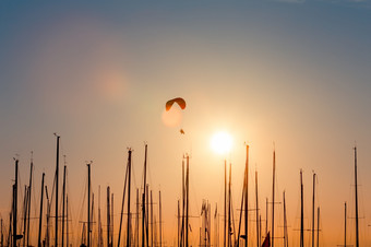 日落跳伞在游艇轮廓和太阳海