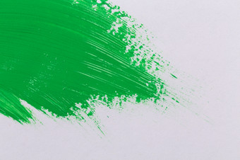 绿色中风的油漆刷白色纸