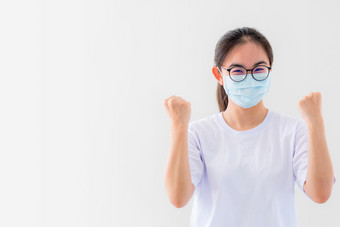肖像亚洲年轻的女人穿眼镜和面具保护对冠状病毒女孩显示拳头鼓励战斗会传染的疾病概念停止病毒科维德爆发赢得白色背景女人持有拳头显示鼓励