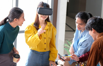 移动电话应用程序测试亚洲女人与虚拟现实眼镜耳机触碰空气在的经验年轻的亚洲业务团队开发人员会议为现实模拟器智能手机应用程序测试有创意的办公室启动小业务概念