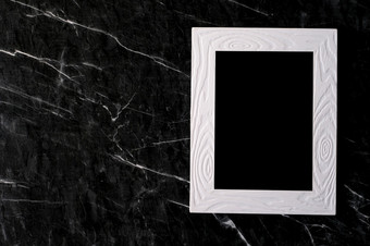 空白色古董木框架白色水泥墙和黑色的大理石地板上背景复制空间为模拟和模板平躺前视图