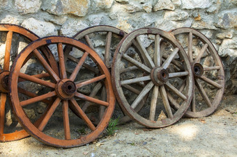 历史被遗弃的褪了色的木车轮子在一起一些历史被遗弃的褪了色的木车轮子在一起