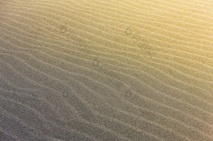 摘要波行纹理太平洋海滩照亮的太阳和空季度的摘要波行纹理太平洋海滩照亮的太阳和空季度