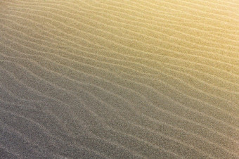 摘要波行纹理太平洋海滩照亮的太阳和空季度的摘要波行纹理太平洋海滩照亮的太阳和空季度