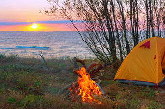 旅游帐篷的海滩帐篷和火日落的海帐篷和火日落的海旅游帐篷的海滩