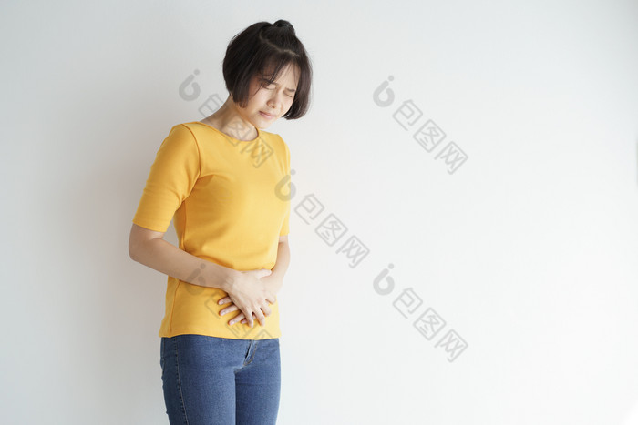 年轻的亚洲女人有痛苦的胃痛白色backgroundchronic胃炎腹部腹胀概念