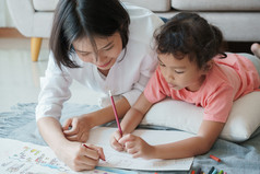亚洲家庭与妈妈。和女儿是画纸首页父母是教学女孩画与颜色白色纸自我研究概念首页
