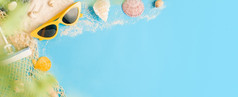 热带夏天海滩海配件对象太阳镜绿色稻草袋航行和海贝在柔和的蓝色的背景横幅