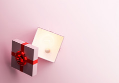 粉红色的礼物盒子与光灯泡内部孤立的粉红色的背景渲染