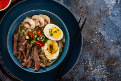 传统的亚洲厨房拉面汤与牛肉蘑菇和蛋