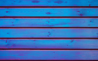 色彩斑斓的有创意的背景纹理水平木木板染色发光的蓝色的和紫色的颜色空白模板为复制蓝色的与紫色的木木板变形背景