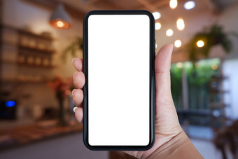 特写镜头手持有电话垂直使用聪明的电话与模糊背<strong>景房</strong>子咖啡馆室内复制空间