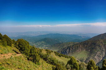 田园夏天景观与徒步旅行小道的山与美丽的新鲜的绿色山牧场蓝色的天空和云tian-shan吉尔吉斯斯坦田园夏天景观与徒步旅行小道的山与美丽的新鲜的绿色山牧场