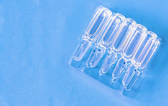 医疗灯泡的表格透明的包装蓝色的背景医疗玻璃灯泡关闭医疗灯泡的表格透明的包装蓝色的背景医疗玻璃灯泡