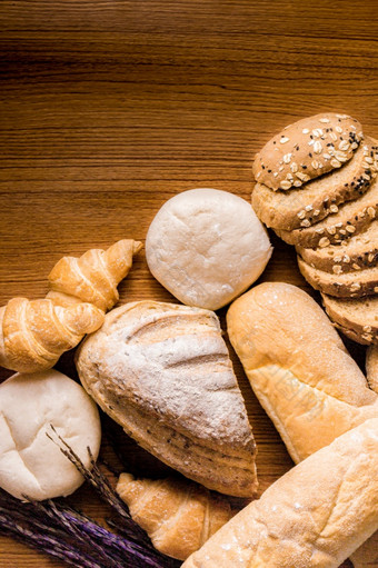 面包概念几个片黑暗棕色（的）面包与种子面包羊角面包和饼面包聚集在一起的木背景