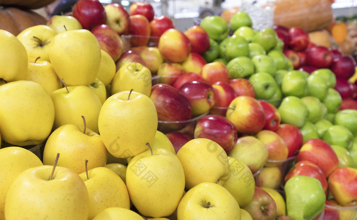 明亮的黄色的苹果金各种和其他品种苹果谎言的计数器为出售的市场多汁的苹果背景黄色的红色的绿色水果为出售的市场