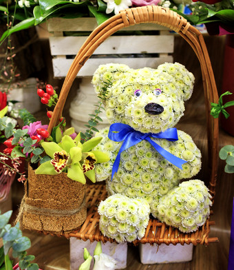 特写镜头美丽的作文玩具熊从小盛开的菊花柳条篮子框架与大兰花花有趣的作文玩具熊从小盛开的菊花