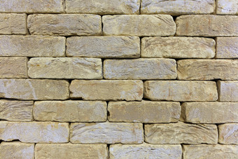 纹理和背景的墙的老石头从beige-golden<strong>砂岩</strong>的形式砖砌的的纹理的石头墙的老砖建筑石头beige-golden<strong>砂岩</strong>