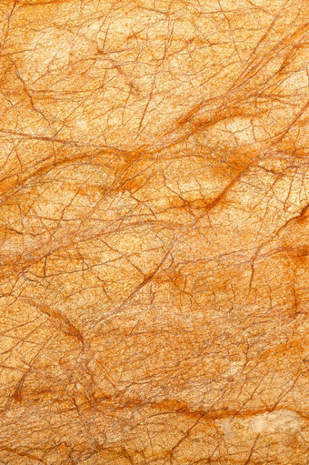 不寻常的发光的纹理老橙色大理石与棕色（的）对角裂缝和划痕垂直图像发光的大理石纹理明亮的橙色颜色与对角裂缝