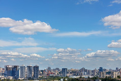 蓝色的天空与白色云浮动在城市摩天大楼下建设清晰的夏天一天复制空间城市景观与新高上升住宅建筑下夏天多云的天空