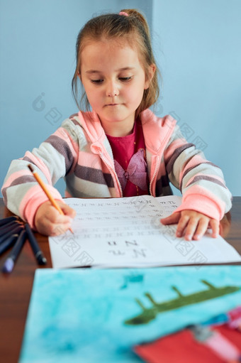 小女孩学龄前儿童学习写信首页孩子使用蜡笔做家庭作业概念早期教育