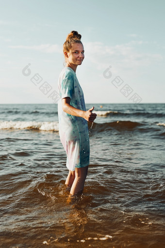 女孩显示好吧手势站水支出免费的时间在海在夏天假期日落女孩显示好吧手势站水支出免费的时间在海在夏天假期