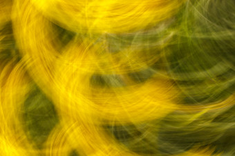 摘要纹理和背景模糊照片花与运动效果黄色的和绿色颜色快运动<strong>快门</strong>定向模糊运动效果