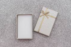 开放灰色的礼物盒子与弓银闪亮的背景最小的风格前视图复制空间模型开放灰色的礼物盒子与弓银闪亮的背景最小的风格前视图复制空间模型